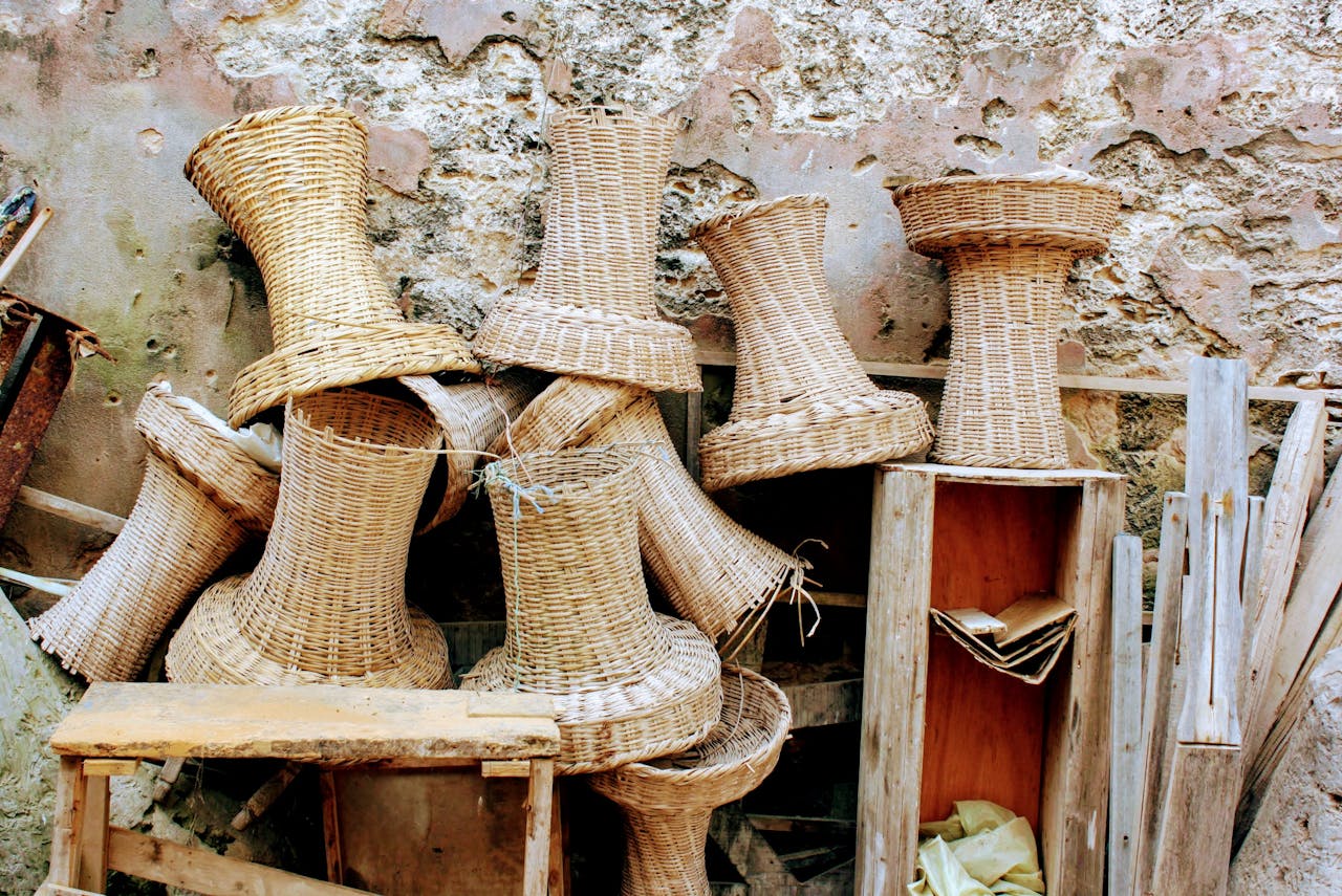 Stacked wicker baskets against a rustic wall in Essaouira, Morocco, showcasing local craft.